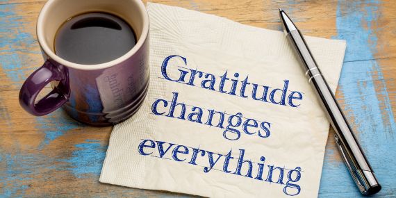 New Ways To Be Grateful During The Holidays - coffee cup and a gratitude sign