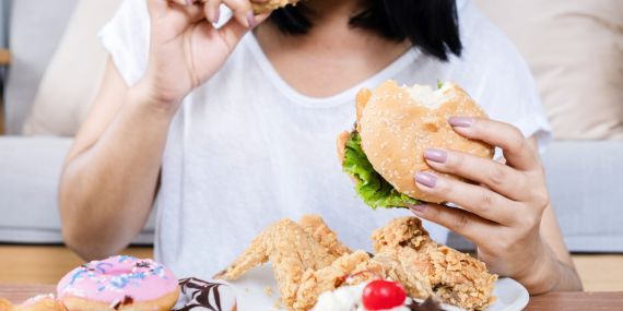 Strategies To Stop Emotional Eating To Control Your Life - woman over eating food