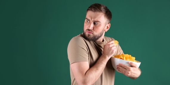 Stop Falling Off The Diet Wagon - guy hiding chips