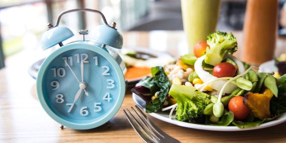 The Easy To Follow Intermittent Fasting Guide For Beginners - clock with food