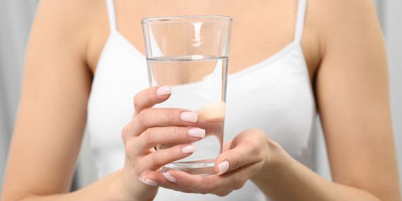 5 Healthy Habits You Can Stick With in 2022 - woman holding water glass