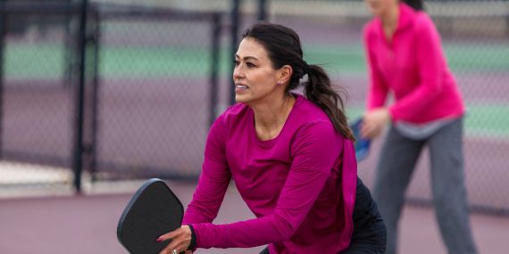 woman playing pickle ball  - 6 Essential Ways To Boost Your Midlife Wellness
