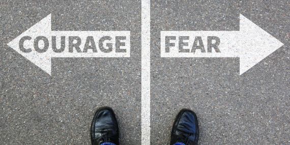6 Ways To Redefine Courage In Midlife -sign saying courage and one says fear
