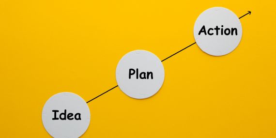 yellow sign saying idea- plan, action