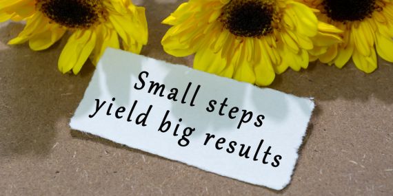 Moving Beyond the All-or-Nothing Wellness Mindset - sign saying small steps yield big results