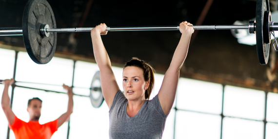 5 Crucial Bone Health Strategies In Midlife - woman lifting heavy weight