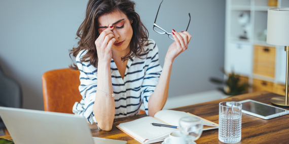 woman sitting on a desk frustrated