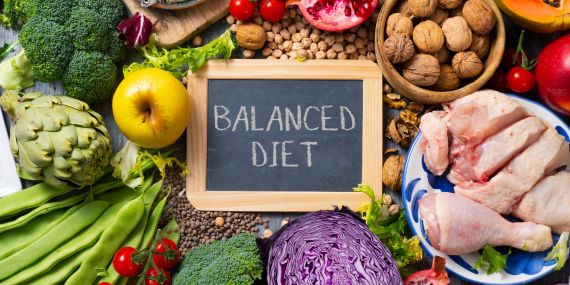 How to Break the Diet Cycle in Midlife - healthy food surrounds a balanced diet sign