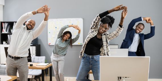 Wellness in the Workplace - people stretching at work