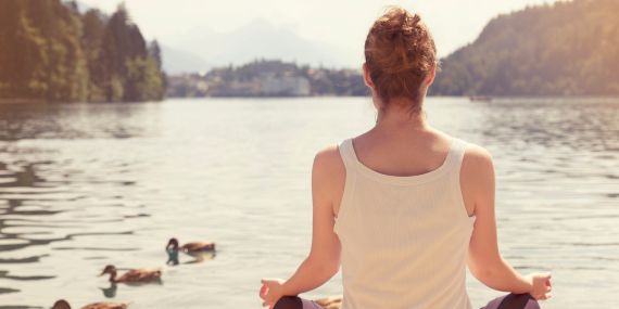 Finding Strength When Life Feels Out Of Control - woman meditating on a lake