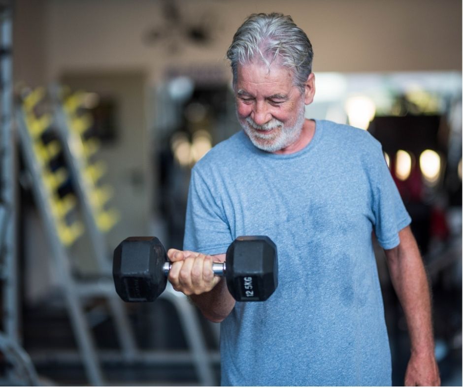 man lifting weights. online fitness and nutrition coaching for midlife adults.