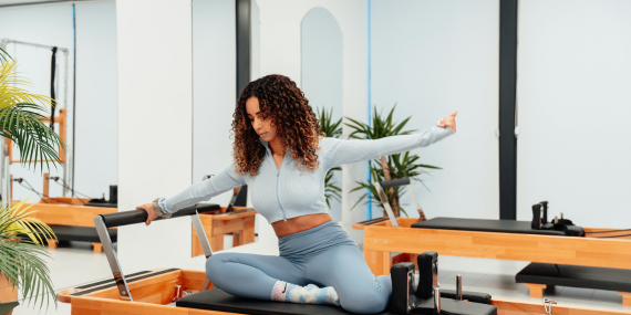 woman doing Pilates on the reformer. Midlife Fitness Mindset: The Real Reason Your Goals Don’t Stick