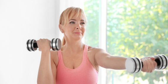 Midlife woman doing weights and works on her midlife fitness mindset