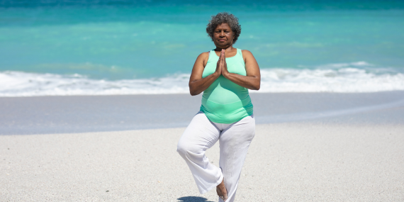 How to Get Back on Track in Midlife When Something Feels Off . Woman doing yoga on the beach.