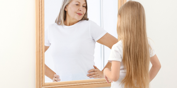 Midlife Consistency for women in midlife. Woman seeing herself as and older self in the mirror