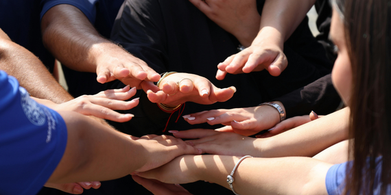 Midlife Consistency: Why Your Routine Stops Working (and What to Do Instead) women laying hands on top of one another.