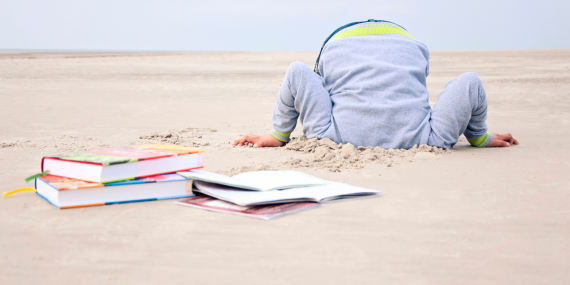 person with the head in the sand surrounded by books. 