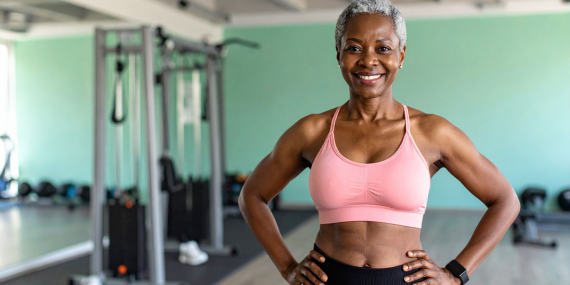 Woman exercising after 50. African American woman smiling at the gym.