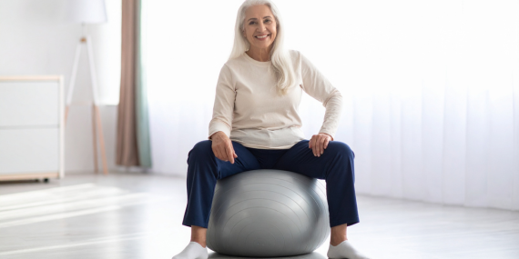 Fitness routine changes in midlife. woman sitting on a stability ball.
